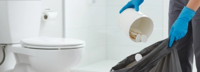 A professionally cleaned bathroom with a spotless floor, showcasing the tidy result of a complete service including Trash and Wastebasket Emptying.