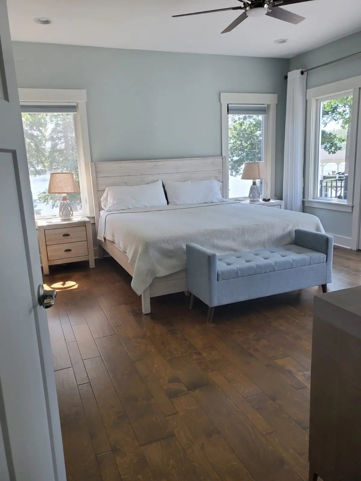A serene and spotless apartment bedroom with hardwood floors, reflecting the high-quality apartment cleaning service provided by Brighthouse Cleaners.