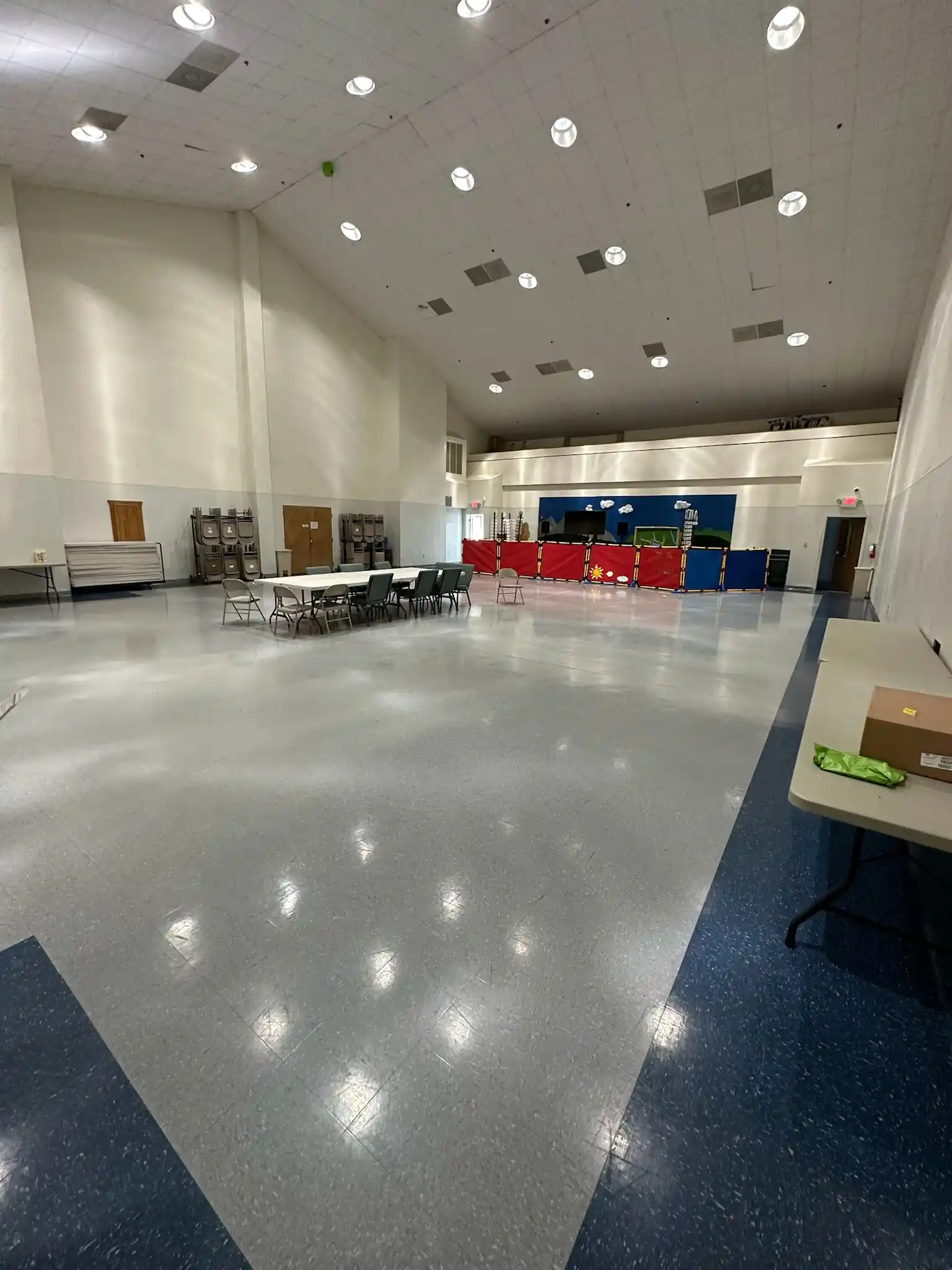 A spacious multi-purpose room with impeccably clean floors, demonstrating the quality of the Brighthouse Cleaners office cleaning service.