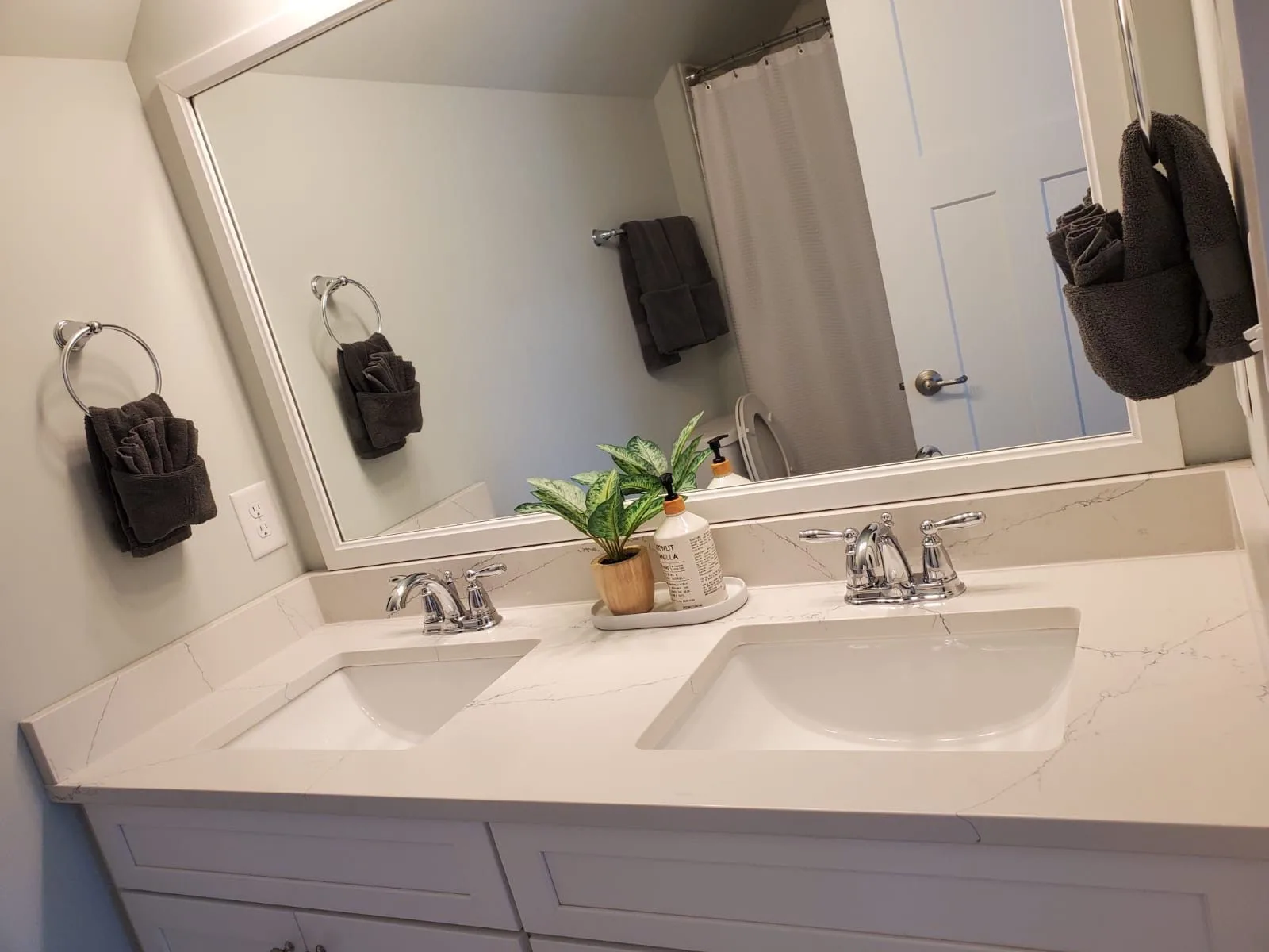 Immaculate bathroom with a double sink vanity, showcasing the results of the professional bathroom cleaning service by Brighthouse Cleaners.
