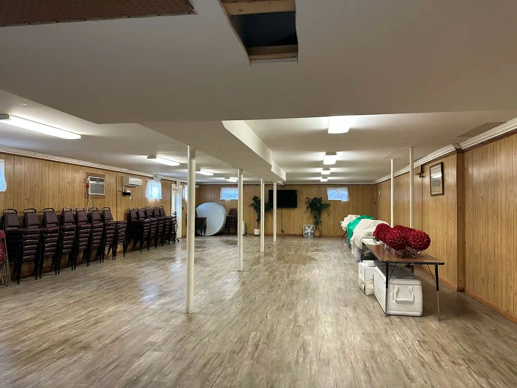 A large, clean event space with polished floors, maintained through the professional office cleaning service by Brighthouse Cleaners.