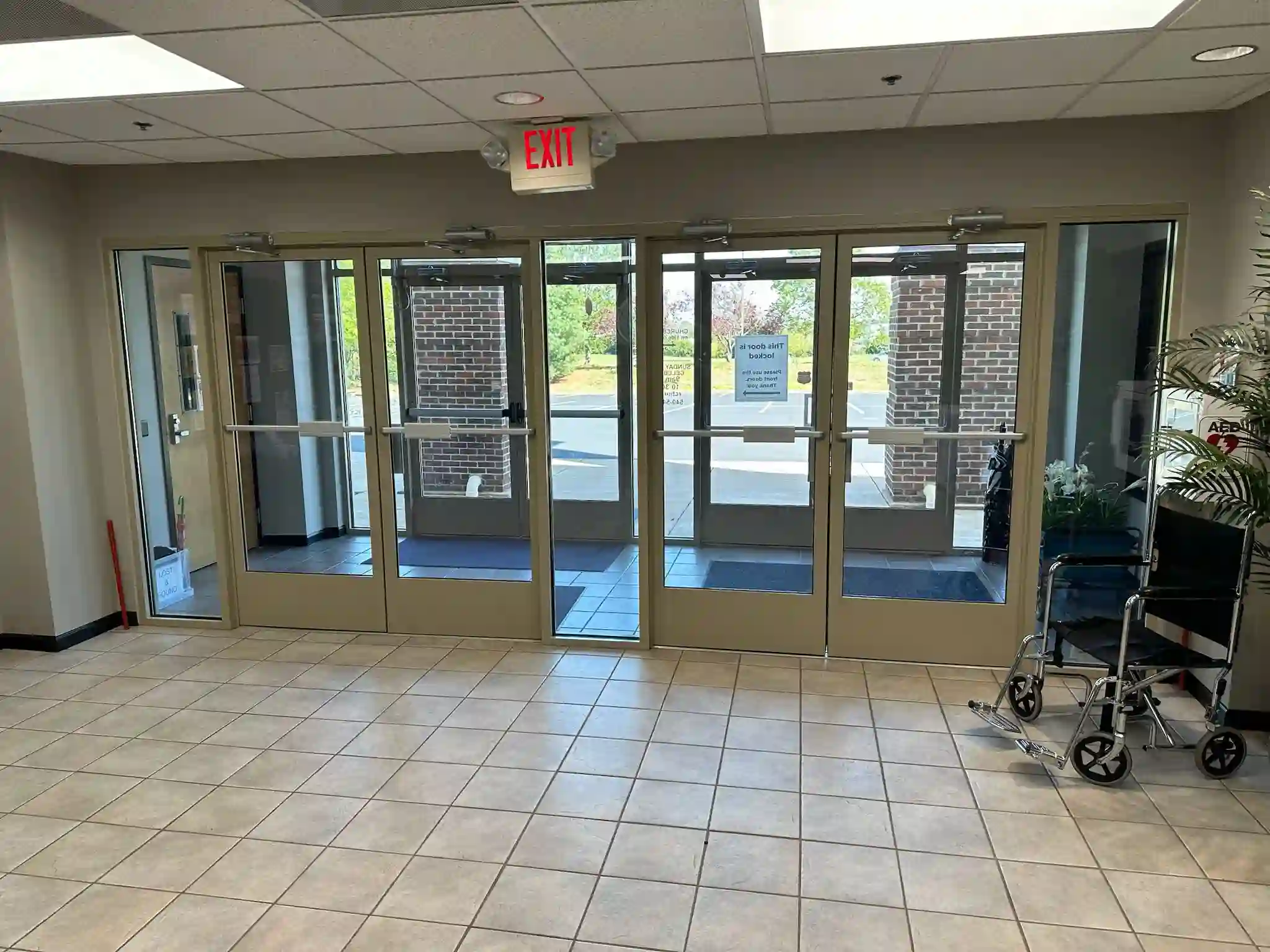 A clean, inviting entrance with sparkling glass doors, reflecting Brighthouse Cleaners' professional window cleaning service in a commercial setting.